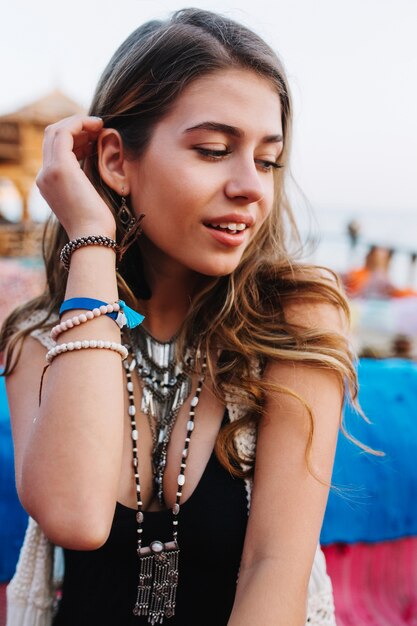 Close-up portrait of gorgeous curly girl with no make-up in black dress, spending time outside