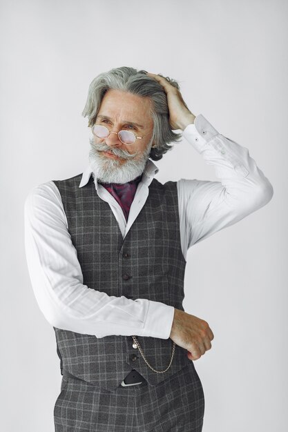 Close up portrait of grinning old-fashioned man.  Grandfather with a clock.