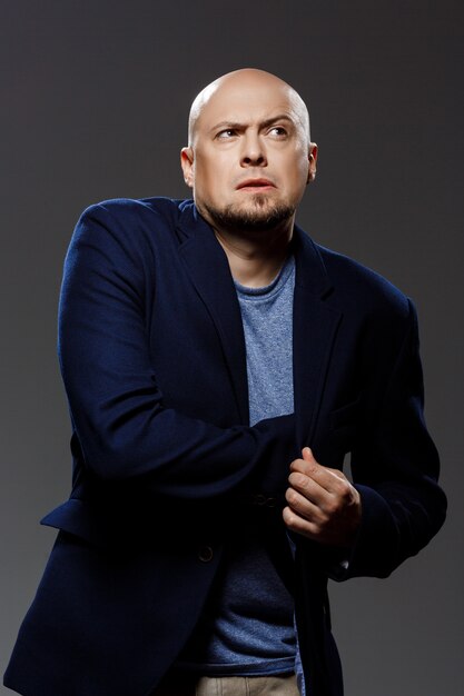 Close up portrait of handsome confident middle-aged businessman over black background.