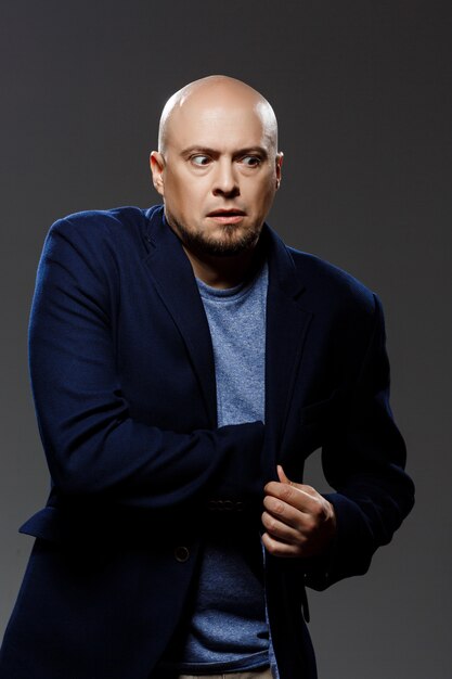 Close up portrait of handsome confident middle-aged businessman over black background.