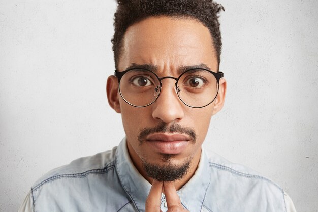 Close up portrait of handsome fashionable young mixed race male with oval face