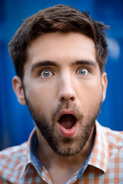 Close up portrait of handsome man surprised