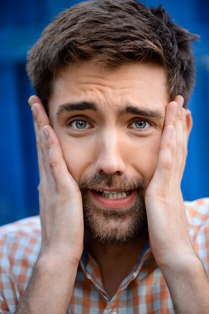 Close up portrait of handsome man upset