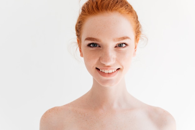 Close up portrait of happy naked ginger woman looking