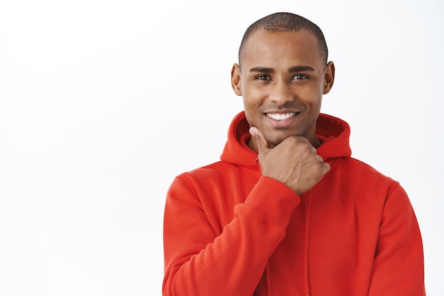 Close-up portrait of intrigued, african-american handsome man making decision, see interesting offer, consider take it