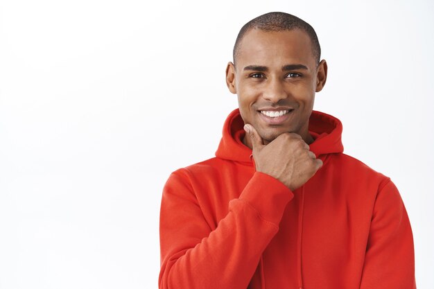 Close-up portrait of intrigued, african-american handsome man making decision, see interesting offer, consider take it