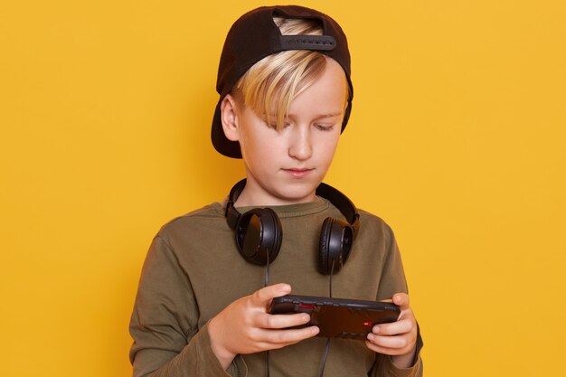 Close up portrait of little blond boy wearing green shirt