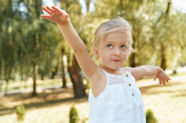 Close up portrait of a little blonde girl on a summer day