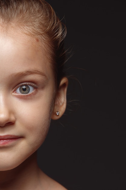 Close up portrait of little and emotional caucasian girl. Highly detail photoshot of female model with well-kept skin and bright facial expression. Concept of human emotions. Calm smiling.