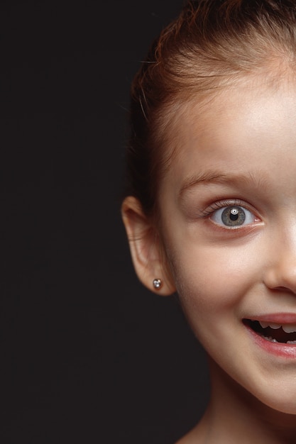 Close up portrait of little and emotional caucasian girl.