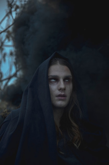 Close-up portrait of man in black fog