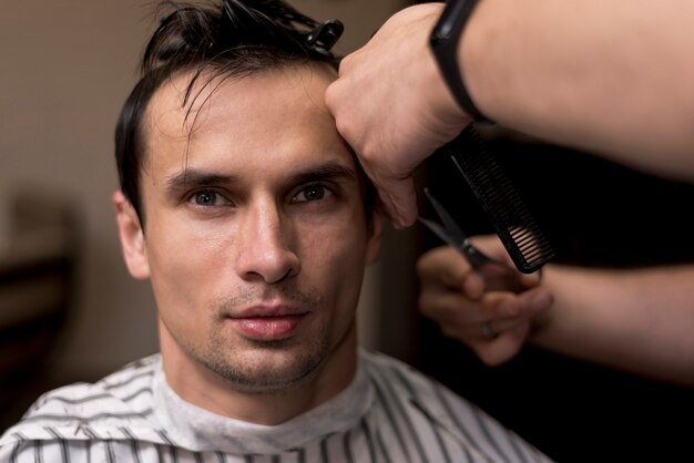 Close up portrait of a man getting a haircut