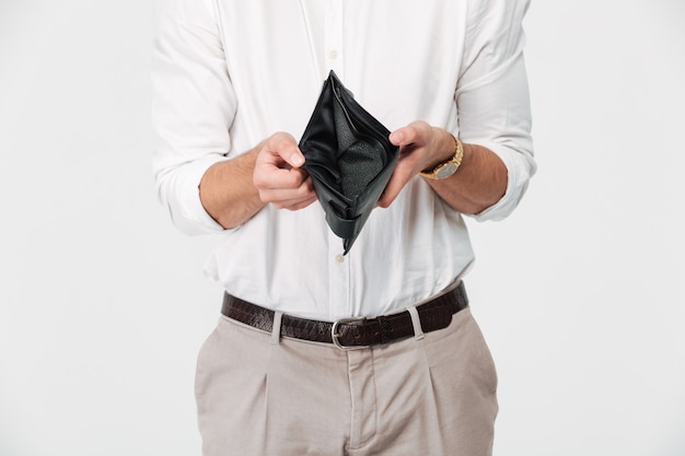 Close up portrait of a man showing empty wallet