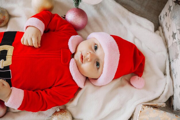 Premium Photo | Close-Up Portrait Of A Newborn Baby. Cute Caucasian Baby 5-6 Months Old In Santa Costume Lying On A Cozy Blanket Near A Decorated Christmas Tree. Merry Christmas 2022