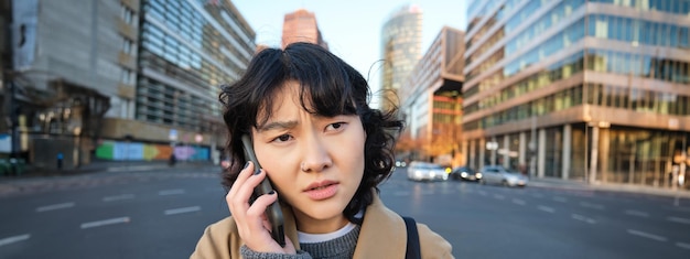 무료 사진 걱정 된 아시아 여성 이 휴대 전화 로 이야기 하고 나쁜 소식 을 듣고 걱정 하고 있는 것 처럼 보이는 자세 한 초상화