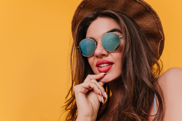 Close-up portrait of pensive young woman in sparkle sunglasses