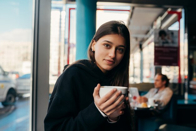 Близкий портрет кофе выпивая довольно вверх по женщине