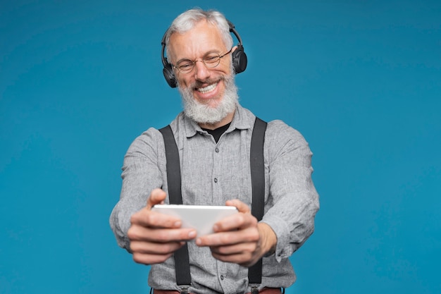 Close up portrait of senior man listening to music