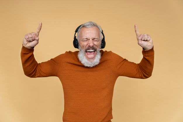 Close up portrait of senior man listening to music