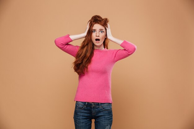 Close up portrait of a shocked young redhead girl