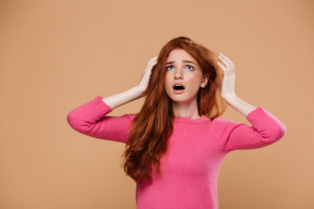 Close up portrait of a shocked young redhead girl