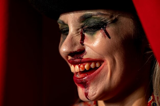 Close-up portrait of sideways clown woman with her eyes closed