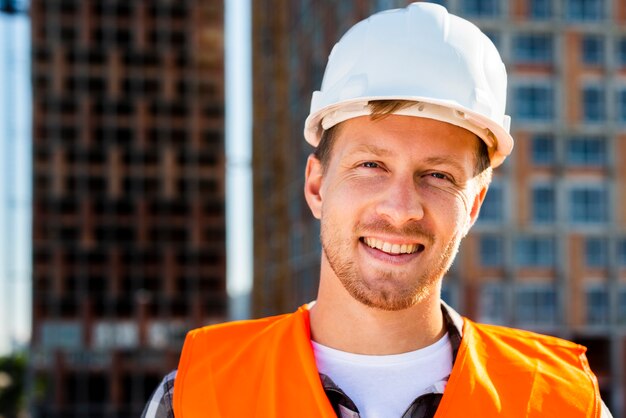 Close-up portrait of smiling construction worker