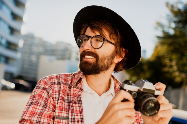 Close up  portrait of smiling  Hipster   beard man using retro film camera