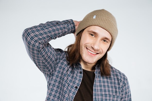 Close up portrait of Smiling hipster holding head