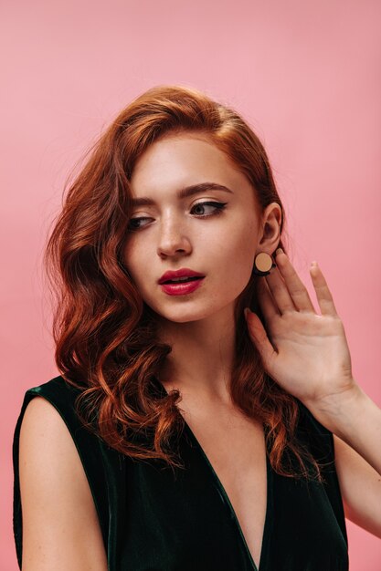 Close up portrait of stylish woman in dark green top