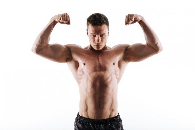 Close-up portrait of sweaty strong sports man showing his biceps