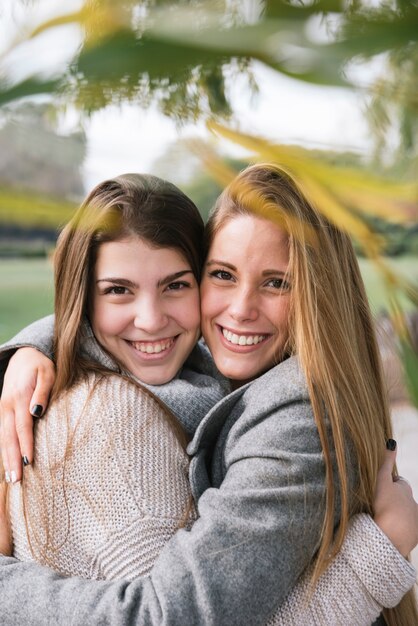 Close up portrait of two smiling young women