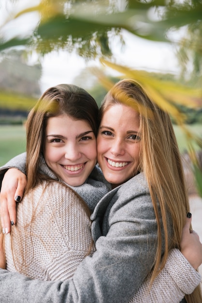 Close up portrait of two smiling young women