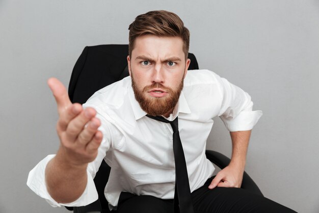 Close up portrait of a unsatisfied man in white shirt