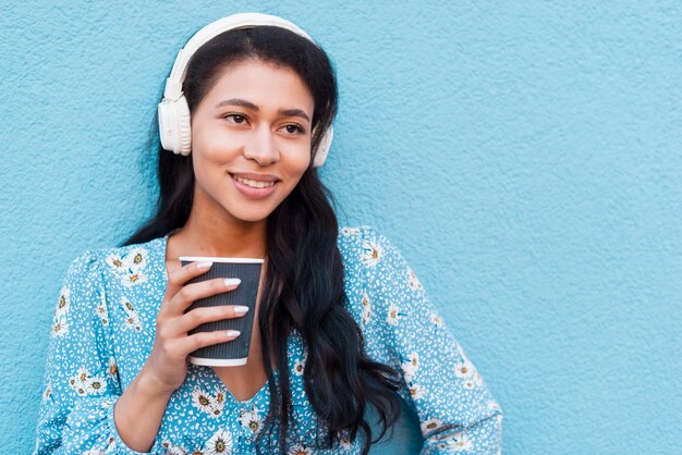 Close-up portrait of woman holding a coffee