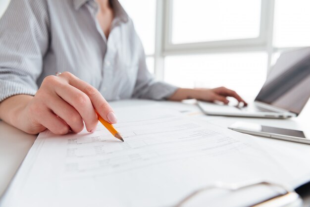 Close up portrait of a woman holding pencil