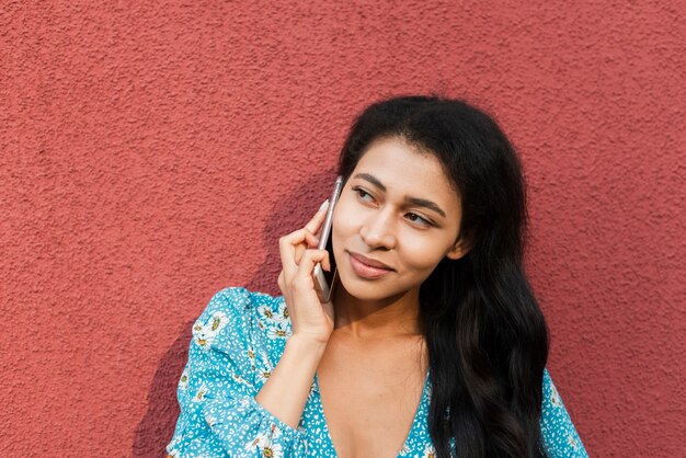 Close-up portrait of woman using her phone