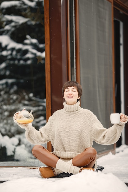 Free Photo close-up portrait of woman in white sweater, drinking tea