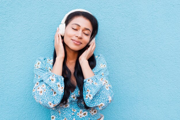 Close-up portrait of woman with headphones 