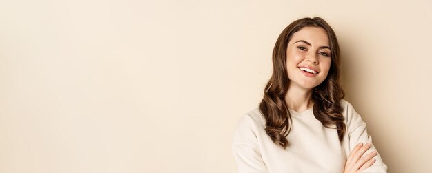 Close up portrait of young caucasian woman with dark hair smiling white teeth laughing posing carefr