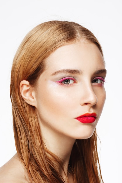 Close-up portrait of young confident woman with light make up.