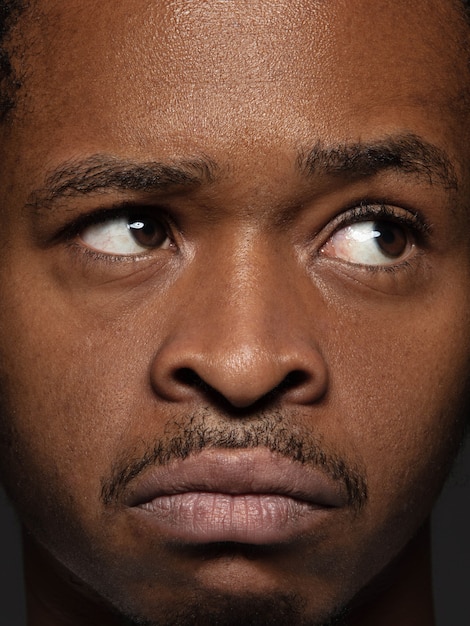 Free photo close up portrait of young and emotional african-american man. male model with well-kept skin and bright facial expression. concept of human emotions. thoughtful.