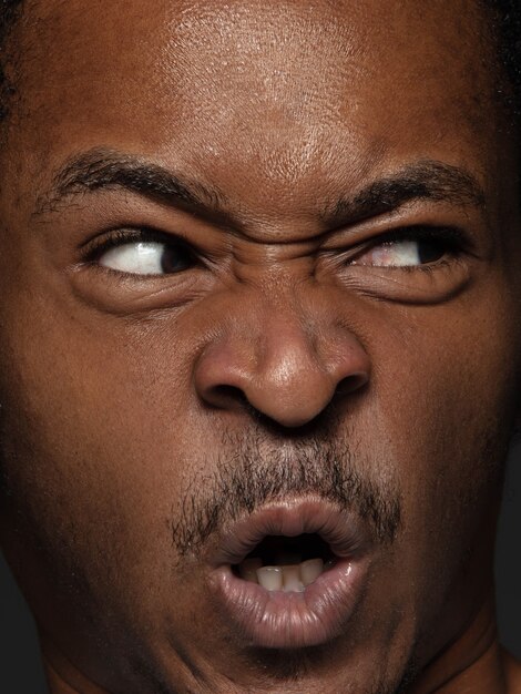 Close up portrait of young and emotional african-american man. male model with well-kept skin and bright facial expression. Concept of human emotions.