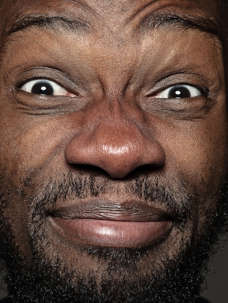 Close up portrait of young and emotional african-american man