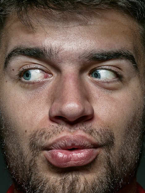 Close up portrait of young and emotional caucasian man. Highly detail photoshot of male model with well-kept skin and bright facial expression. Concept of human emotions. Looks playful.