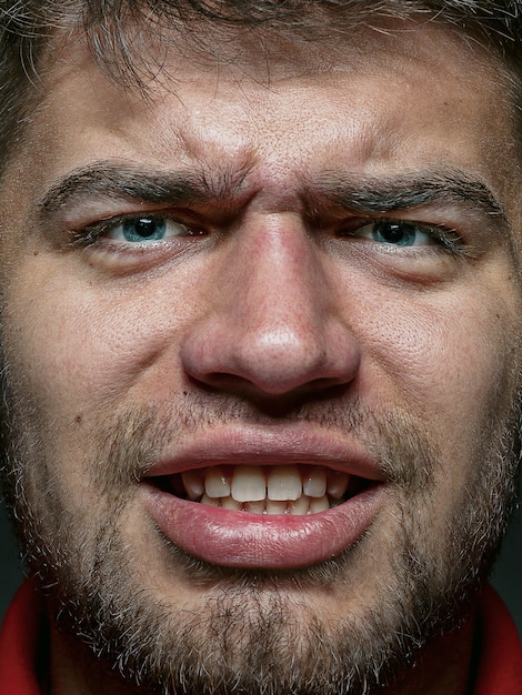 Close up portrait of young and emotional caucasian man