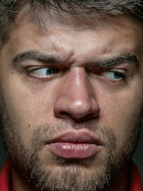 Close up portrait of young and emotional caucasian man