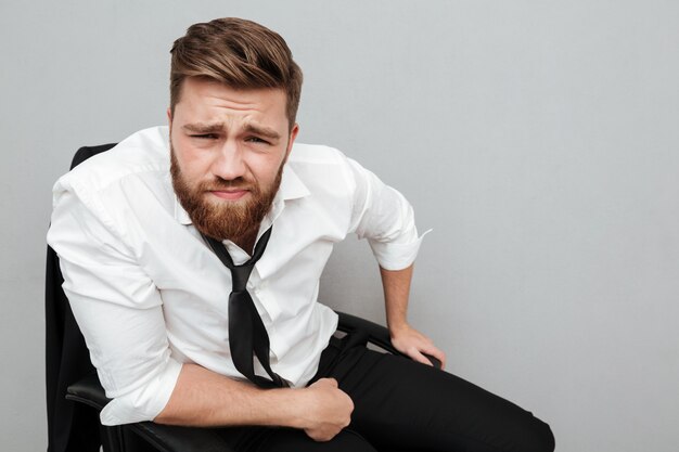 Close up portrait of a young frowning man