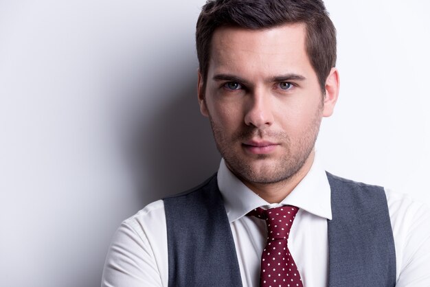 Close-up portrait of a young handsome man in suit posing 