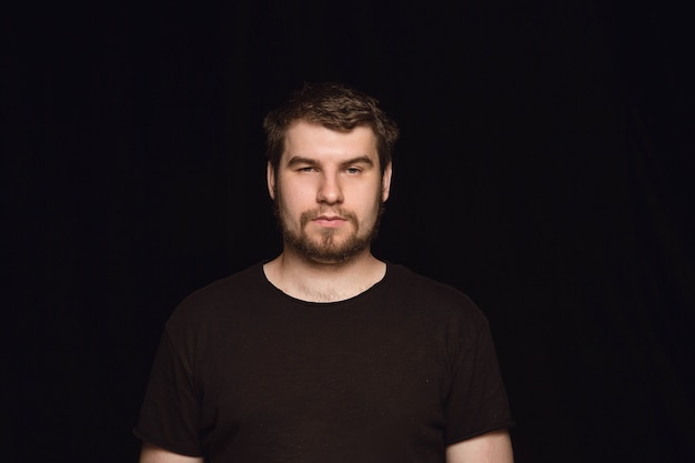 Free photo close up portrait of young man isolated on black studio